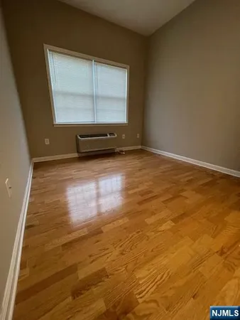 a view of a room with wooden floor and window