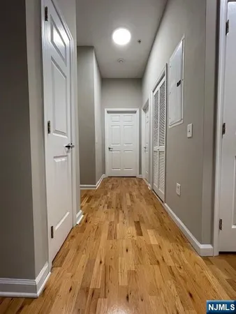 a view of a hallway with wooden floor