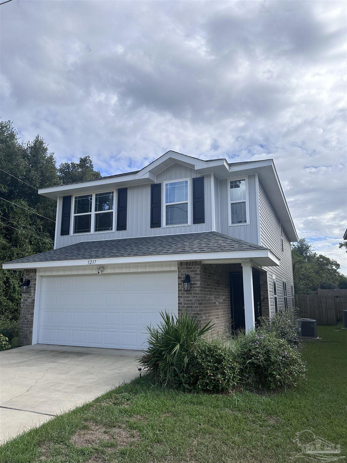 5217 Saufley Field Road Pensacola, FL 32526 - Photo 1 of 26 a front view of house with yard and green space