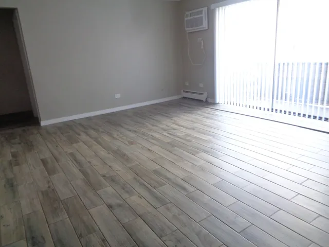 a view of a room with wooden floor and fence