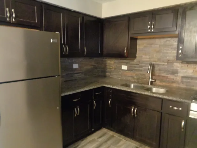 a kitchen with a sink and cabinets