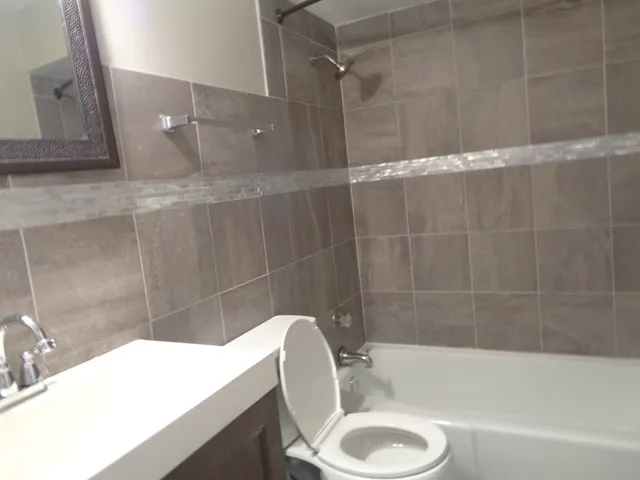 a bathroom with a sink a toilet and bathtub