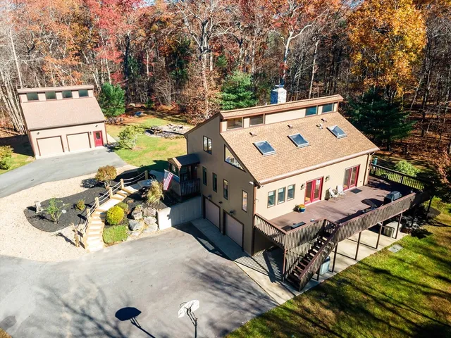 an aerial view of a house with swimming pool and furniture
