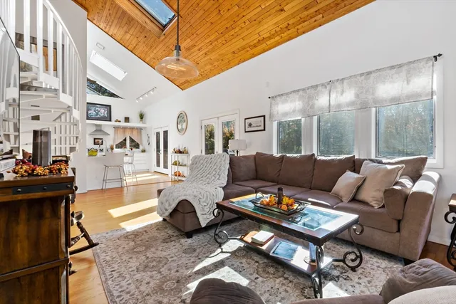 a living room with furniture a rug and a chandelier