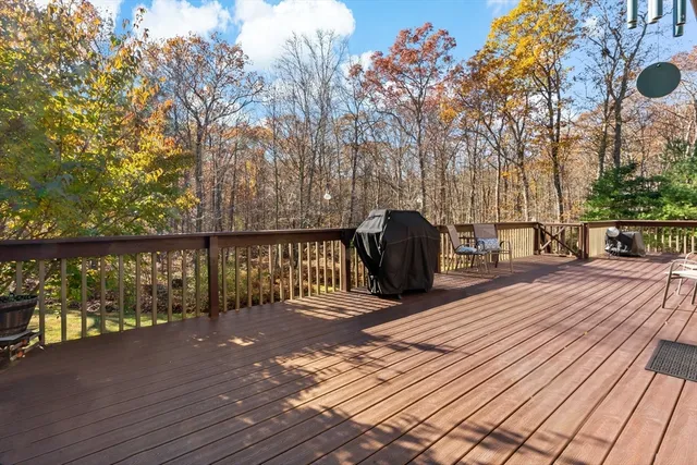a view of a street with trees and wooden fence