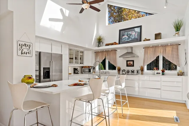 a view of a dining room with furniture and a kitchen