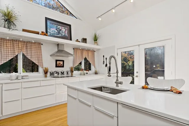 a kitchen with a sink and a stove top oven