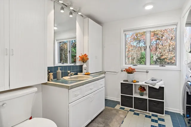 a room with a window open kitchen view and living room