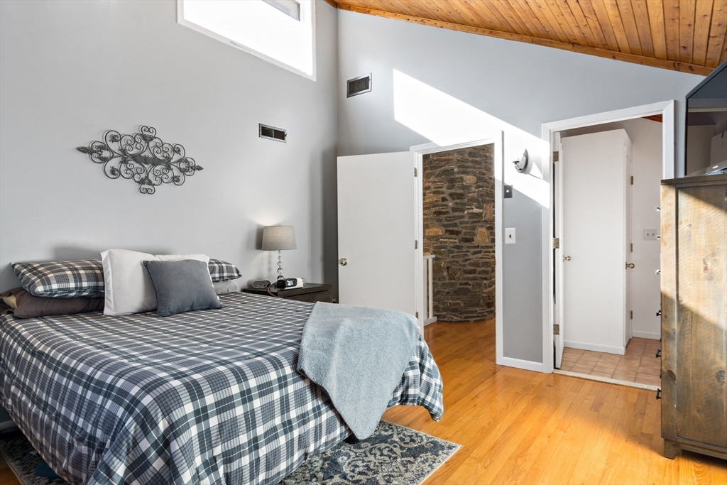 15 Carpenter Street Rehoboth, MA 02769 - Photo 33 of 42 a bedroom with a large bed and a chandelier