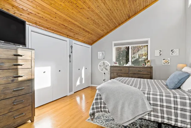 a bedroom with a bed and flat screen tv