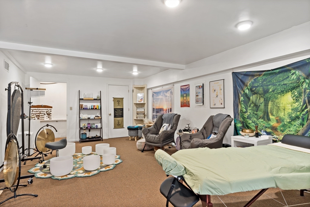 15 Carpenter Street Rehoboth, MA 02769 - Photo 37 of 42 a room with furniture a large window and a chandelier