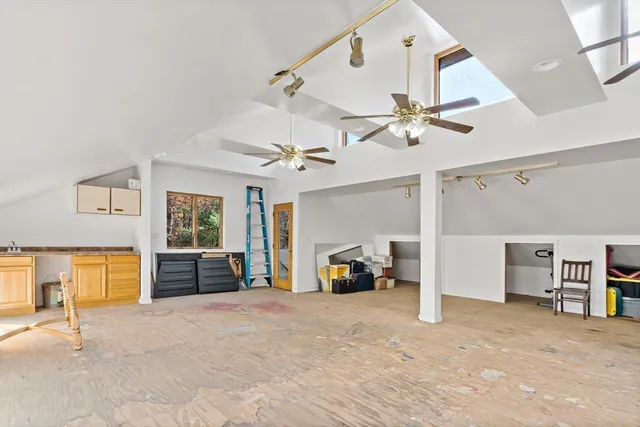 a view of a livingroom with furniture and a ceiling fan