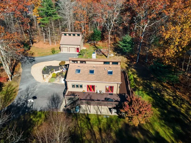 an aerial view of a house with a yard