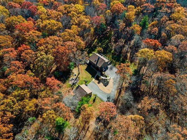 view of a house with a yard and sitting area