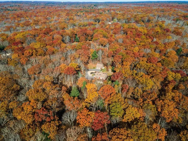 an aerial view of residential houses with city view