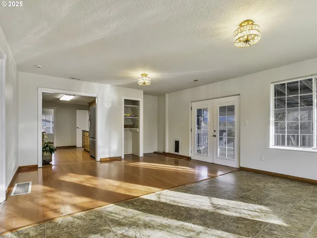 a view of a livingroom with wooden floor and a rug