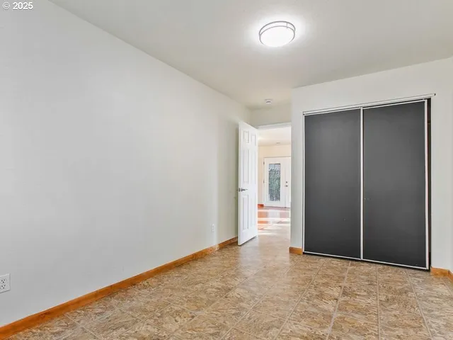 an empty room with closet area