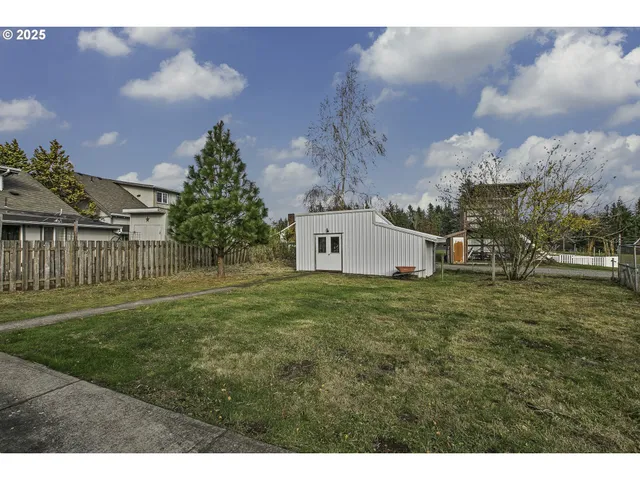 a view of a house with a yard and a garage