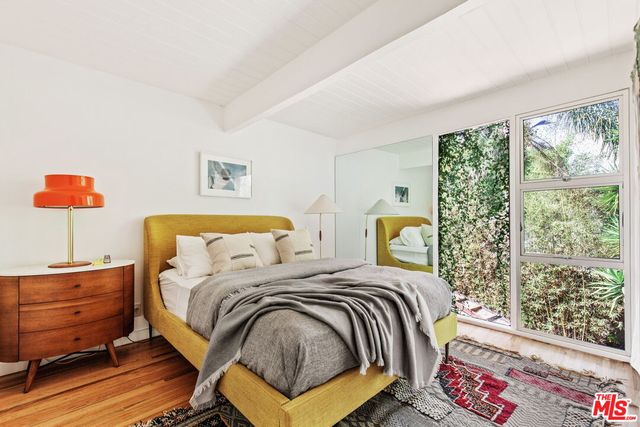 a bedroom with a bed and window