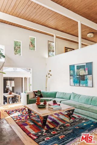 a living room with furniture fireplace and rug