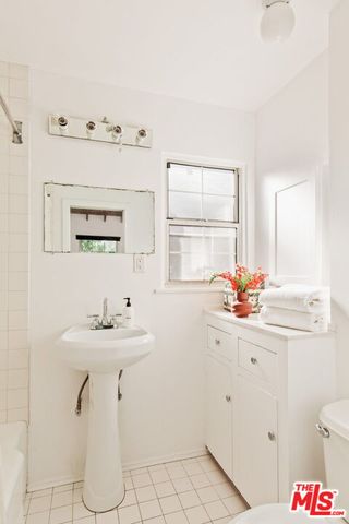 a bathroom with a sink toilet and mirror