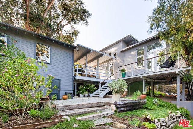 a view of a house with a yard and sitting area