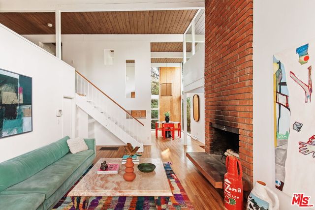 a view of entryway livingroom and hall with wooden floor