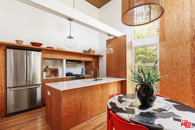 a kitchen with a refrigerator and a stove