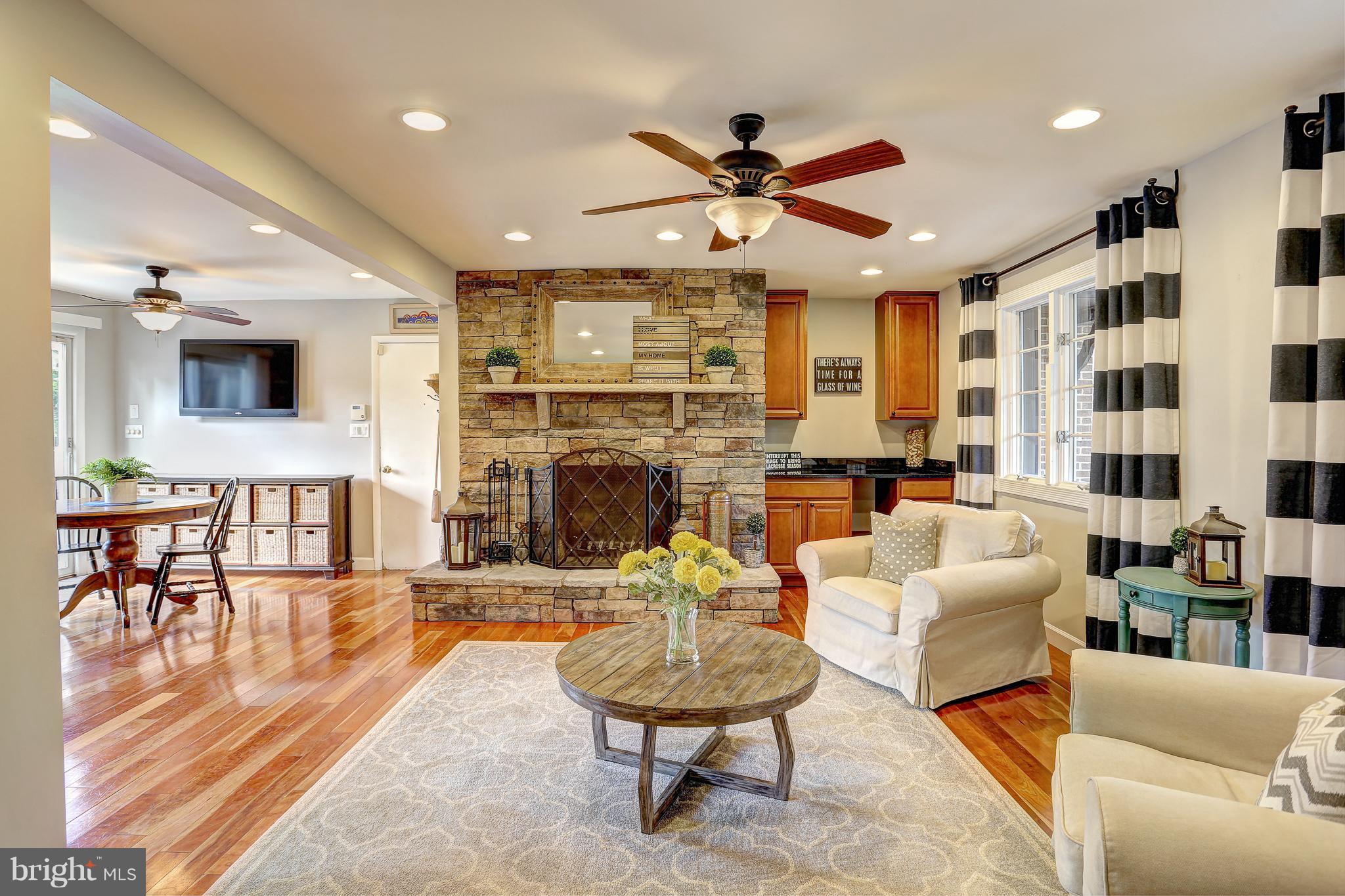 12233 Etchison Road Ellicott City, MD 21042 - Photo 3 of 48 OPEN LIVING ROOM W/STONE FIREPLACE FROM KITCHEN