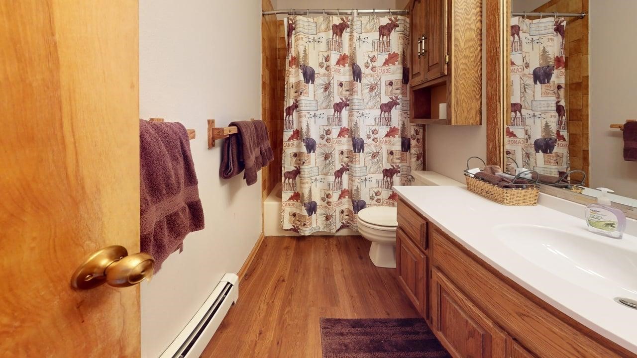 91200 Ryan Gulch Road, Unit 213 Silverthorne, CO 80498 - Photo 26 of 33 a bathroom with a sink toilet and shower