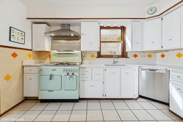 a utility room with cabinets washer and dryer