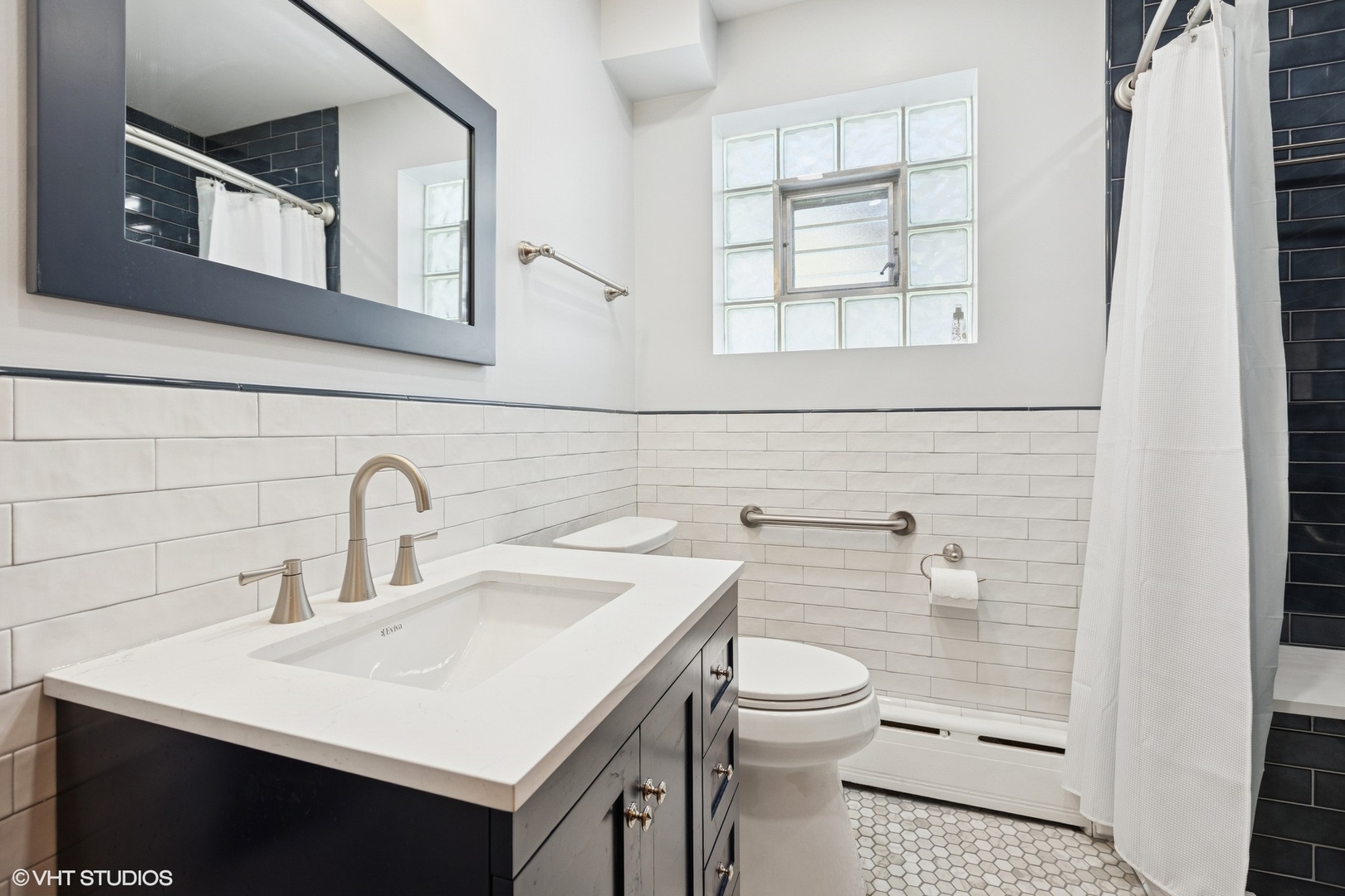 6321 North Merrimac Avenue Chicago, IL 60646 - Photo 10 of 21 a bathroom with a sink toilet and window