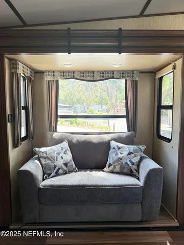 a living room with furniture and a window