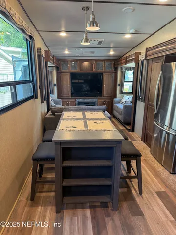 a room with furniture a flat screen tv and a table