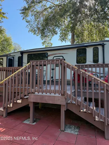 a view of a house with a wooden deck