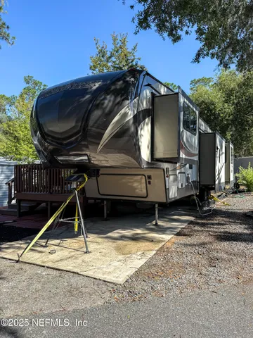a view of a house with a wooden deck
