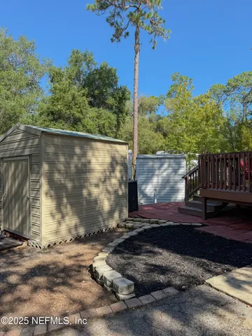 a view of a backyard with a tree