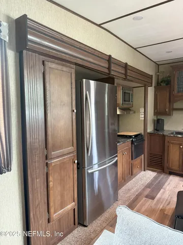 a kitchen with stainless steel appliances granite countertop a refrigerator and a sink