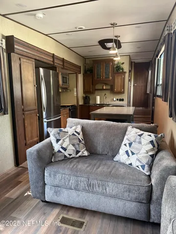 a living room with furniture and a chandelier