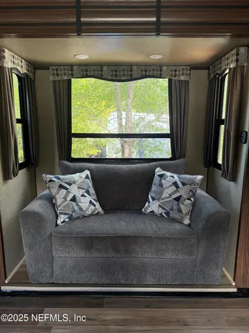 a living room with furniture and a large window