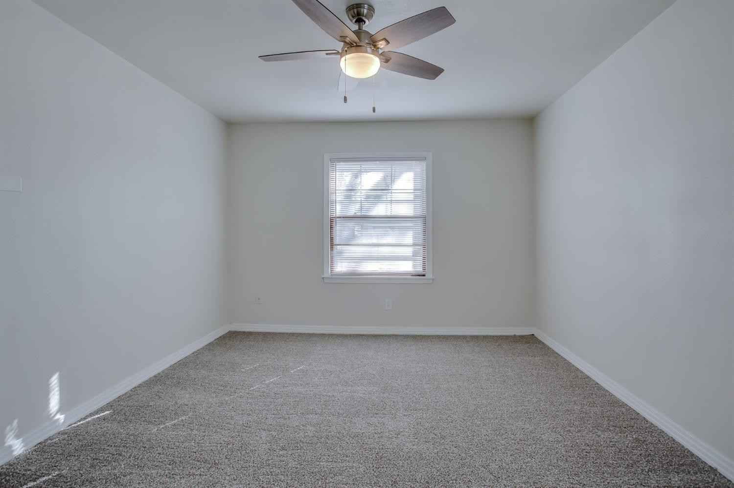 5002 41st Street Lubbock, TX 79414 - Photo 6 of 13 an empty room with a window and a fan
