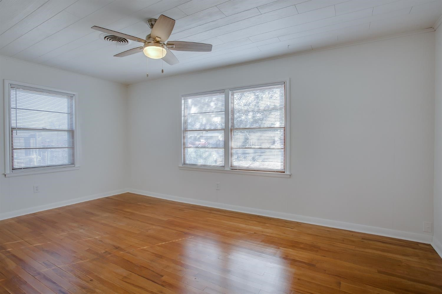 5002 41st Street Lubbock, TX 79414 - Photo 8 of 13 wooden floor in an empty room with a window