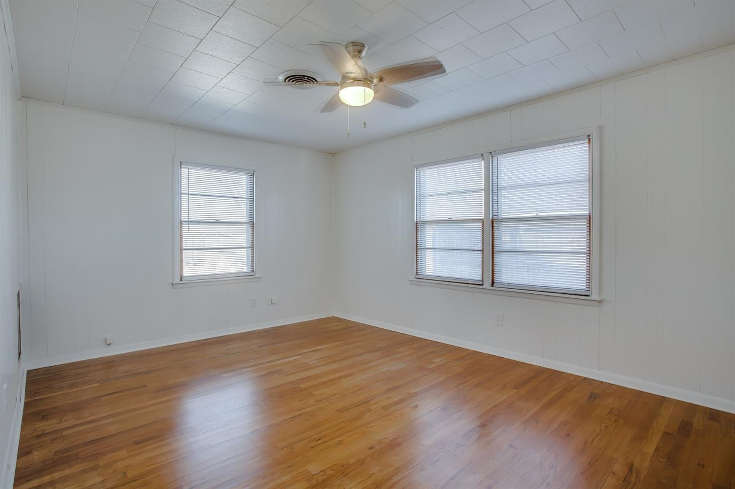 5002 41st Street Lubbock, TX 79414 - Photo 9 of 13 wooden floor in an empty room with a window