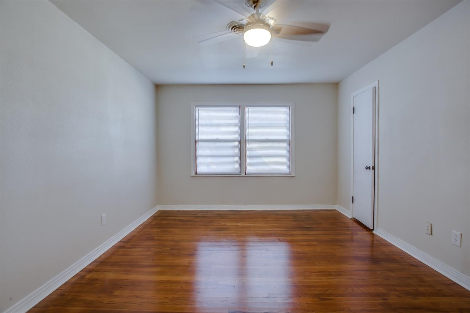 5002 41st Street Lubbock, TX 79414 - Photo 10 of 13 an empty room with wooden floor and windows