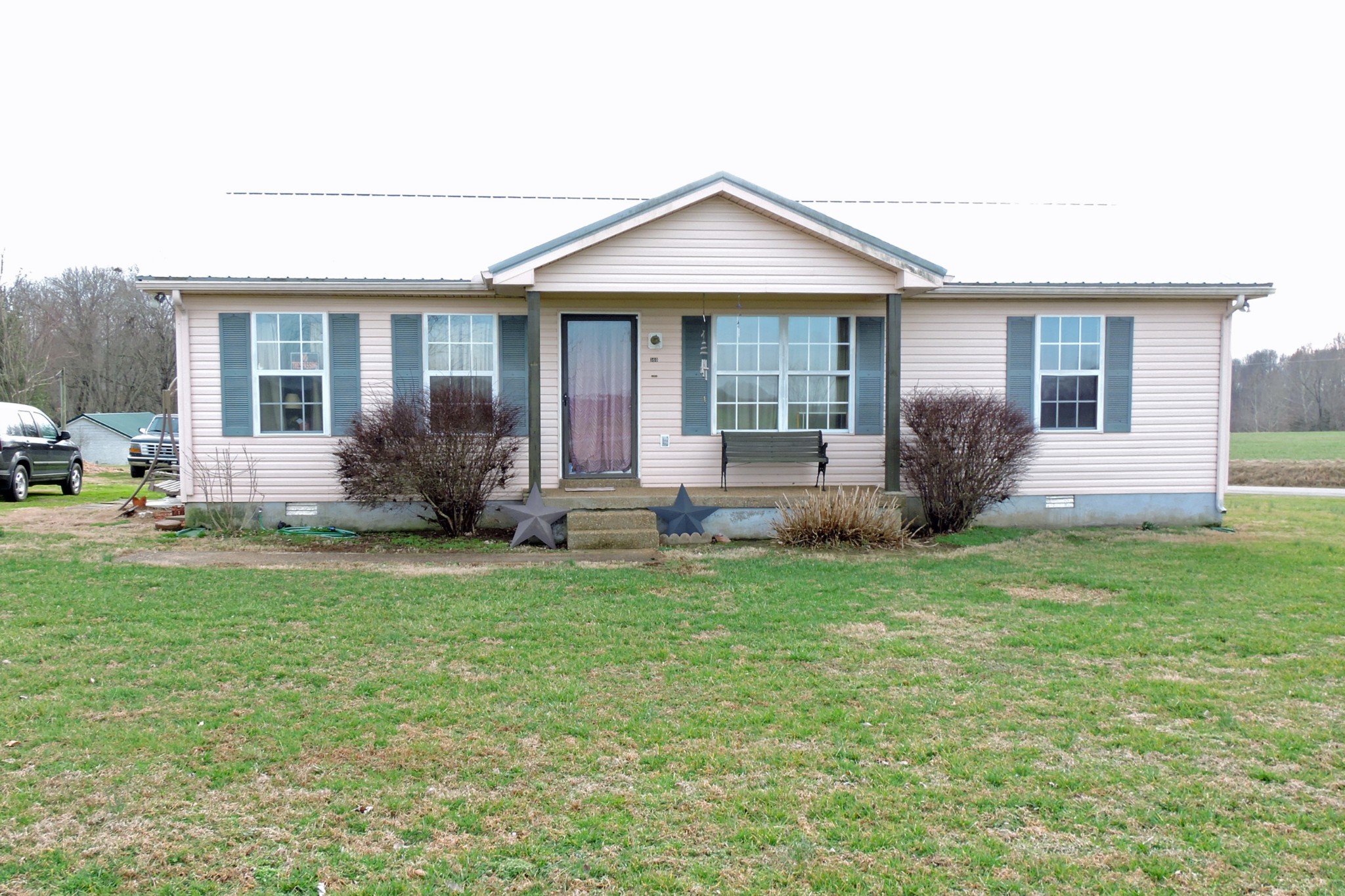 a front view of house with yard and green space