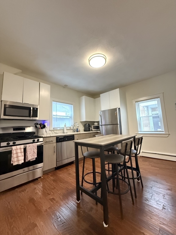 a kitchen that has a table and chairs in it