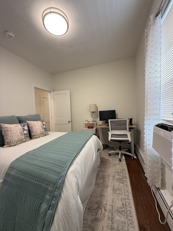 229 Charles Street, Unit 1 Cambridge, MA 02141 - Photo 11 of 19 a bed room with a bed and a chair