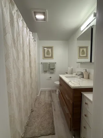a bathroom with a sink a mirror and a shower
