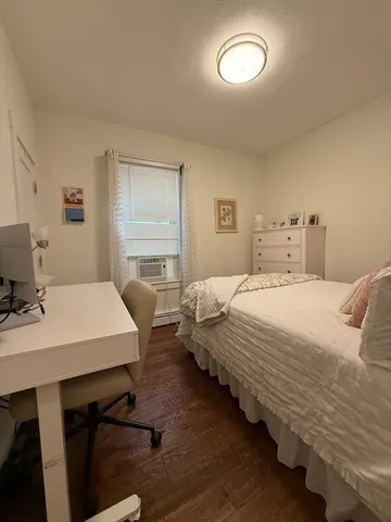 a bedroom with bed and window