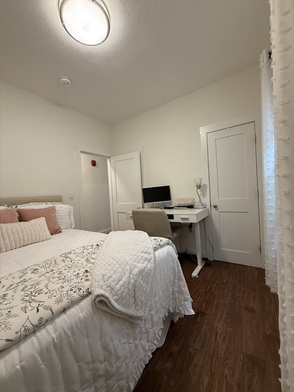 229 Charles Street, Unit 1 Cambridge, MA 02141 - Photo 15 of 19 a bedroom with a bed and wooden floor